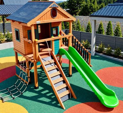 Wooden playhouse with green slides — Elysee