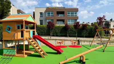 Wooden playhouse with a red slide — Elysee