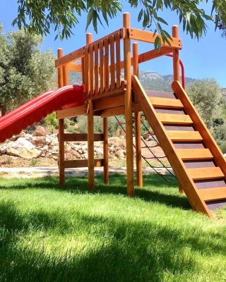 Wooden playground with red slides — Elysee