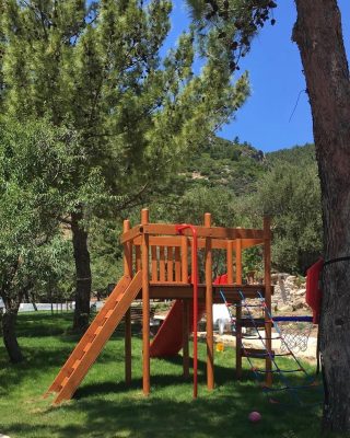 Wooden playground with red slides — Elysee