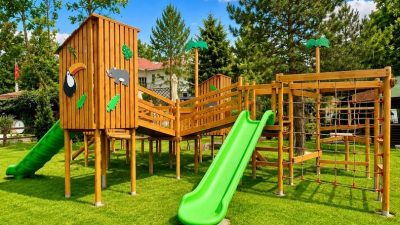 Natural wooden playground with green slides — Elysee
